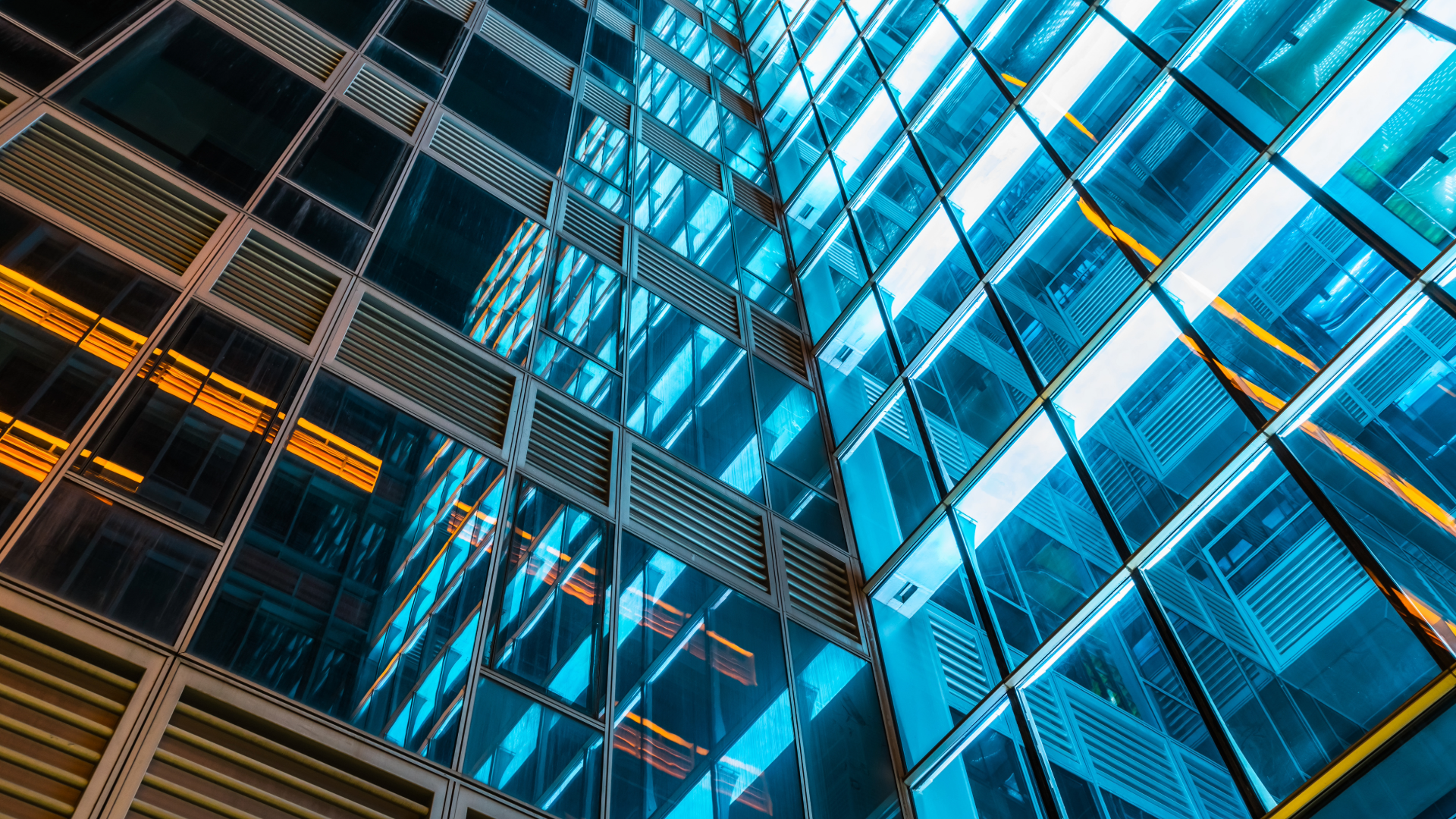 side of a skyscraper building with blue lights reflecting