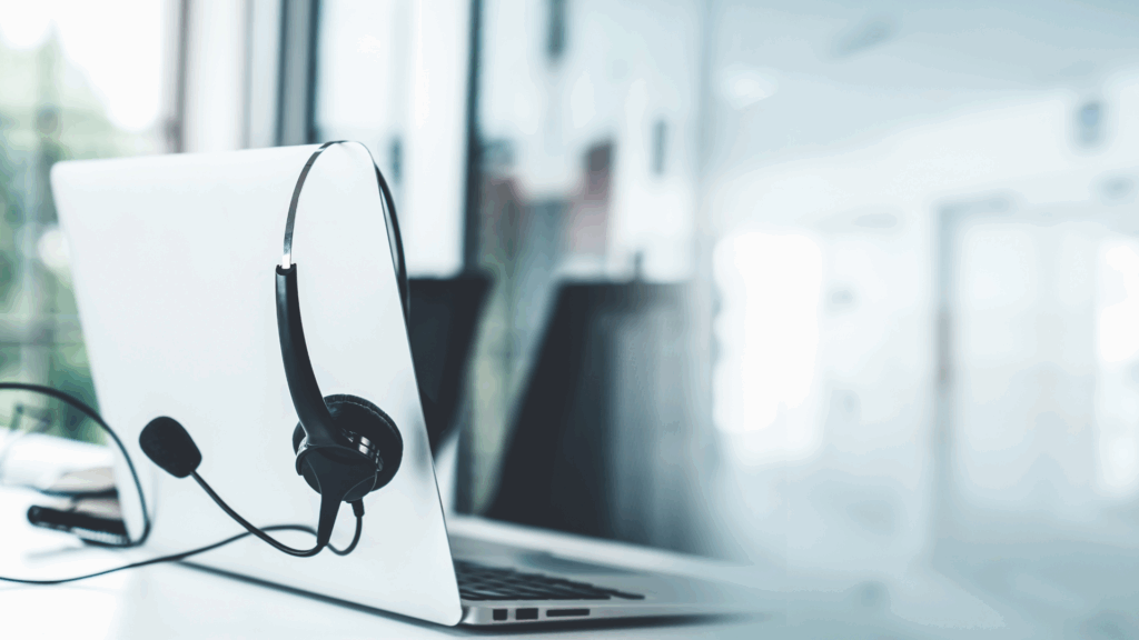 headphones hanging off laptop computer