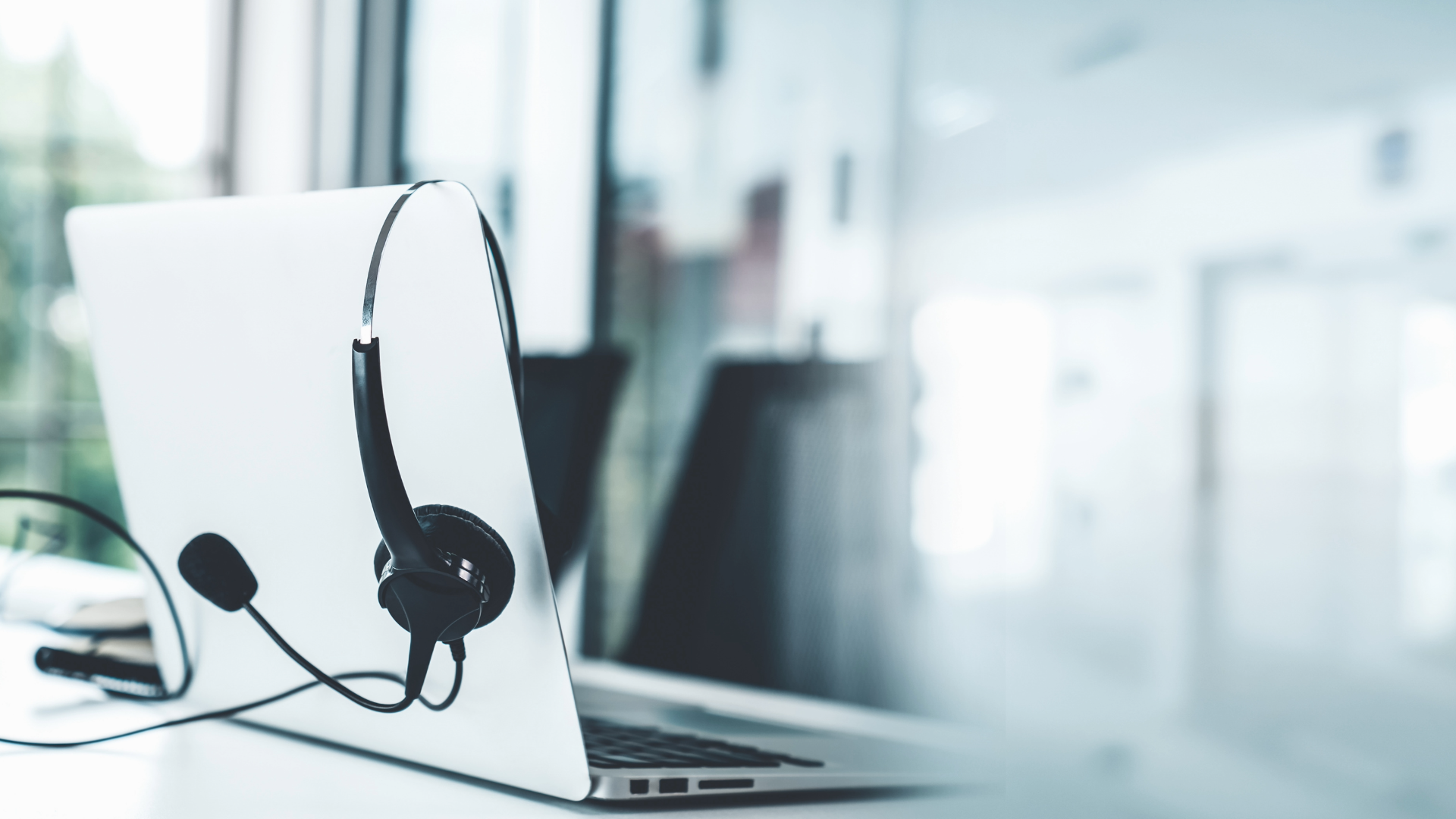 headphones hanging off laptop computer